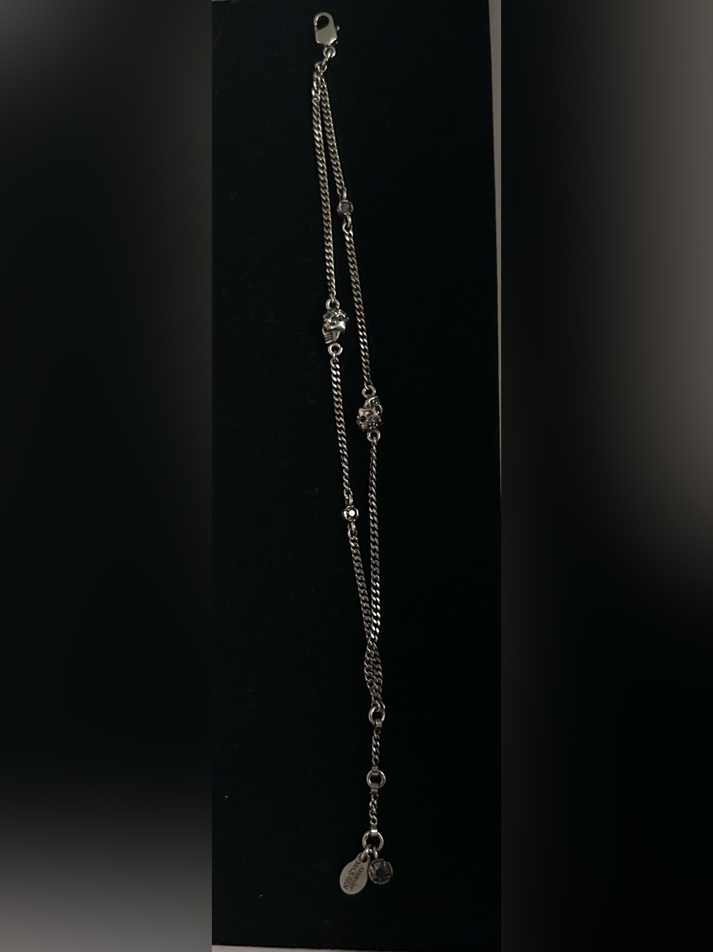 Alexander McQueen silver double chain skull bracelet with blue crystal accents